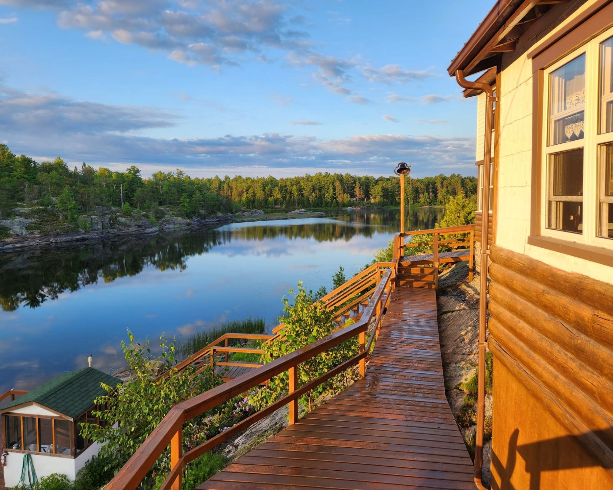View from the deck on a sunny day at Bear's Den Lodge on the French River