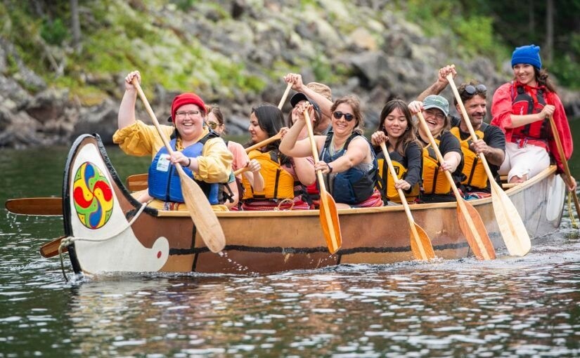 A tour group paddles a traditional big canoe down the Mattawa River.