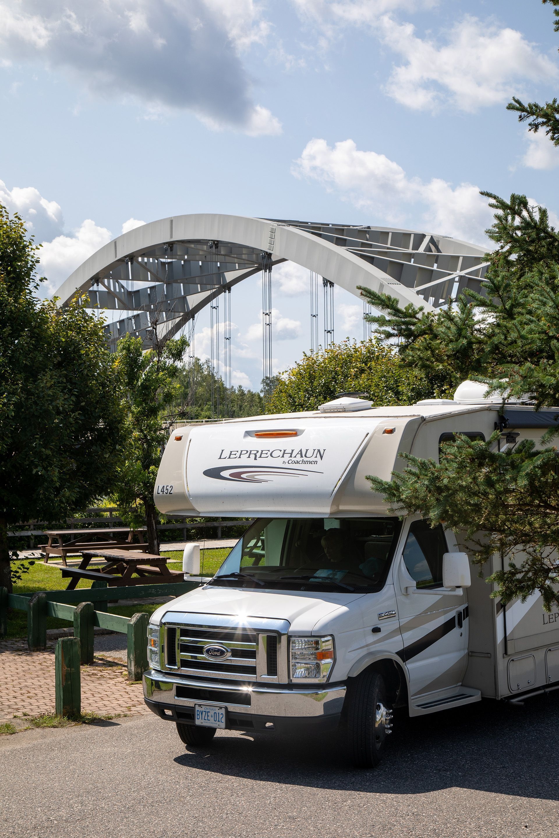 An RV is parked beside a the Sgt. Aubrey Cosens VC Memorial Bridge near Temagami.