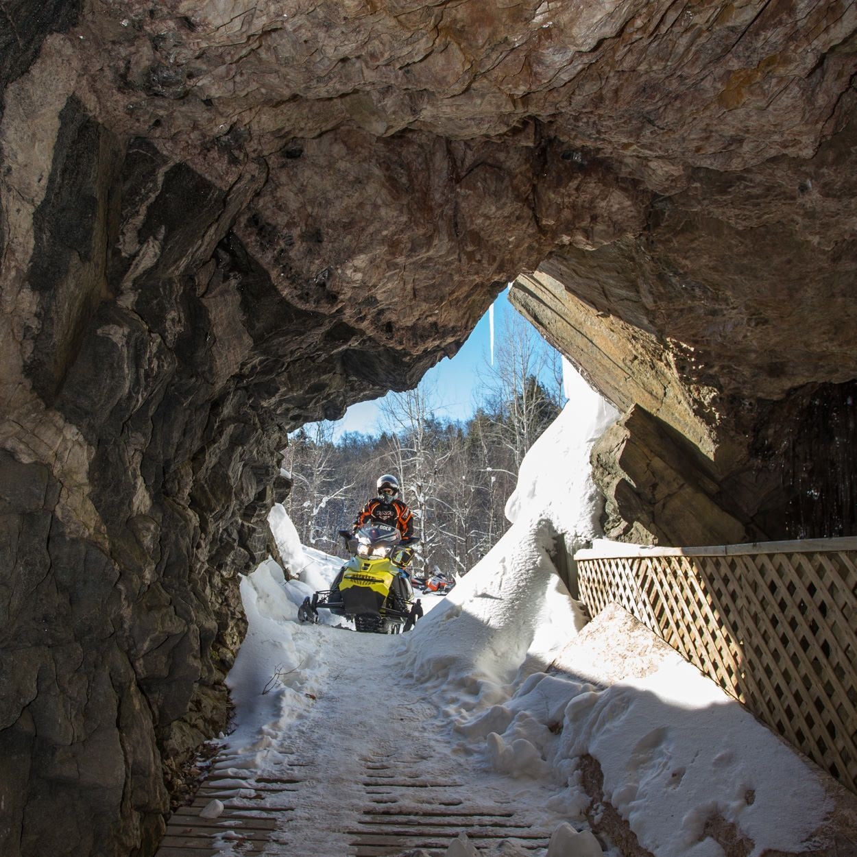Someone on a snowmobile turns into a rocky tunnel.
