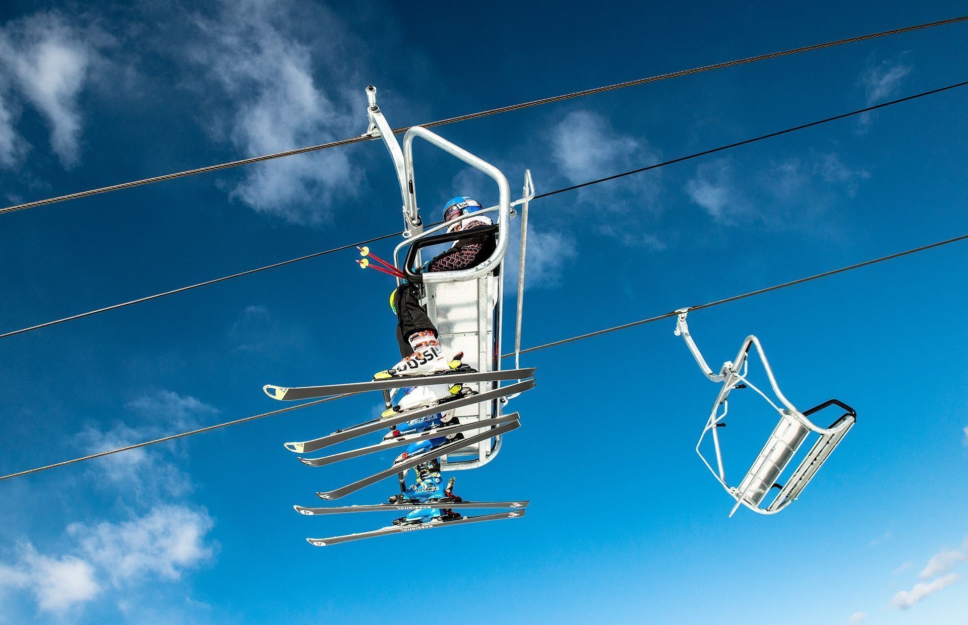 A view from below a chairlift at a ski hill.